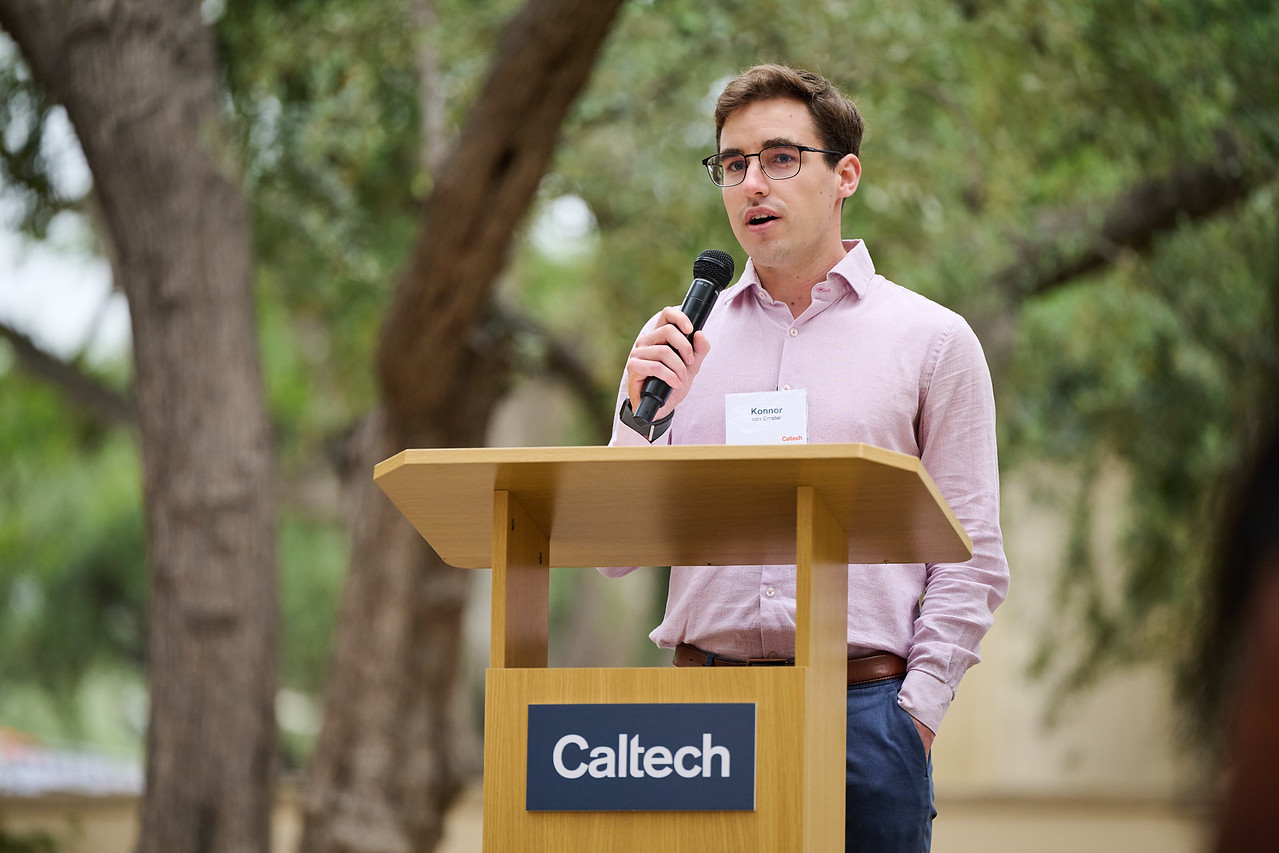 Konnor von Emster speaking at a Caltech podium outdoors